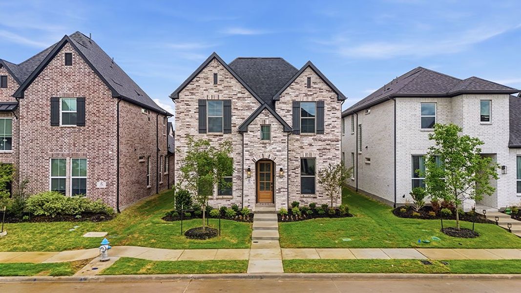 Front exterior of a new home in Light Farms Brenham - 40' Lots, Celina, TX, highlighting curb appeal (Image 28). Front exterior of a new home in Light Farms Brenham - 40' Lots, Celina, TX, highlighting curb appeal (Image 28).
