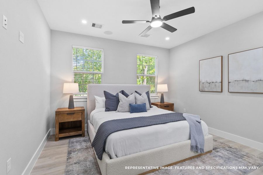 Your primary bedroom feels like a retreat, where the soft gray tones and natural light make every morning feel fresh and calm.