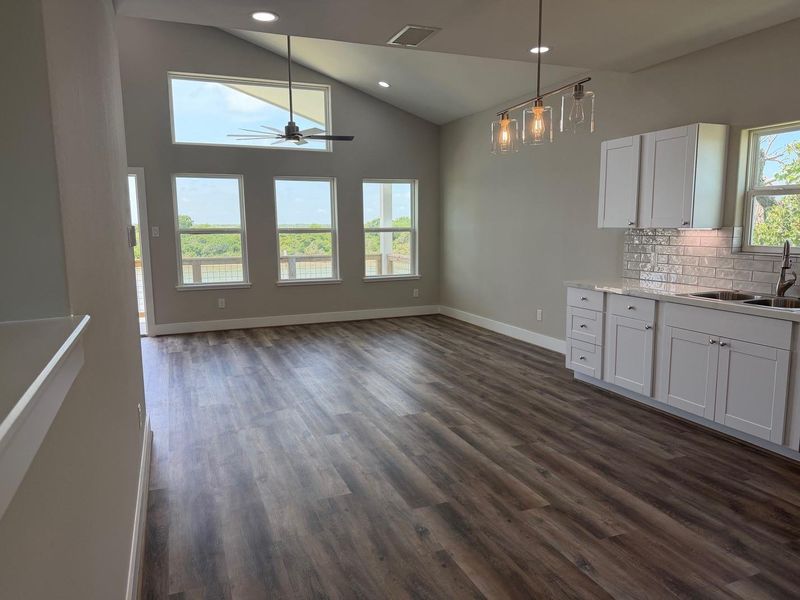 Living room has abundant natural lighting   and opens into the Kitchen. Main floor/2nd Floor