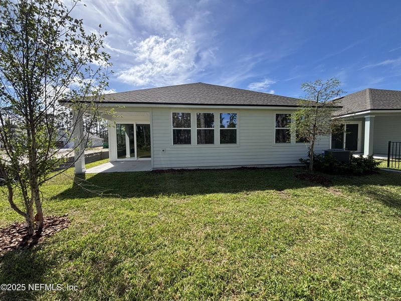 Front exterior of a new home in The Magnolia Series at Reserve East, Flagler Beach, FL, highlighting curb appeal (Image 17).