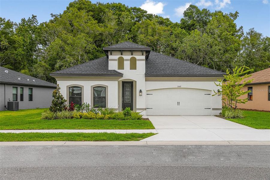 Front exterior of a new home in Hidden Ridge, New Port Richey, FL, highlighting curb appeal (Image 2). Front exterior of a new home in Hidden Ridge, New Port Richey, FL, highlighting curb appeal (Image 2).