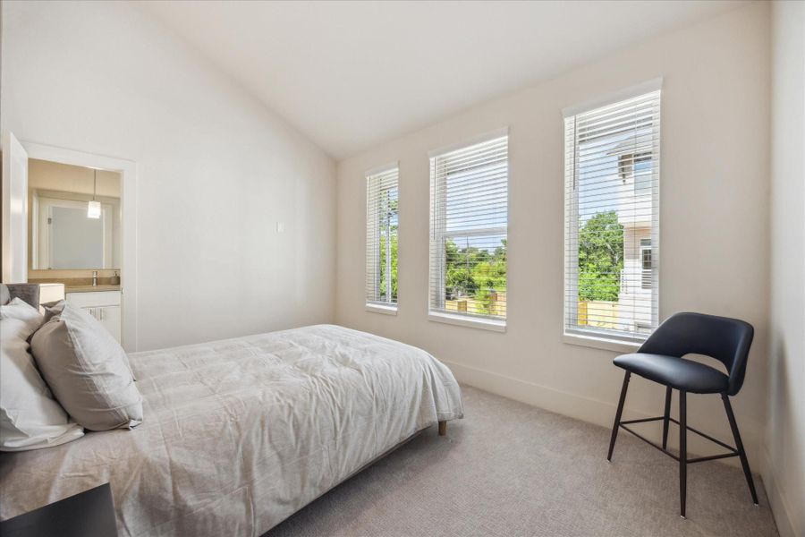 Secondary bedroom. With direct access to a full bath, it’s ideal for guests or family members seeking both comfort and privacy.