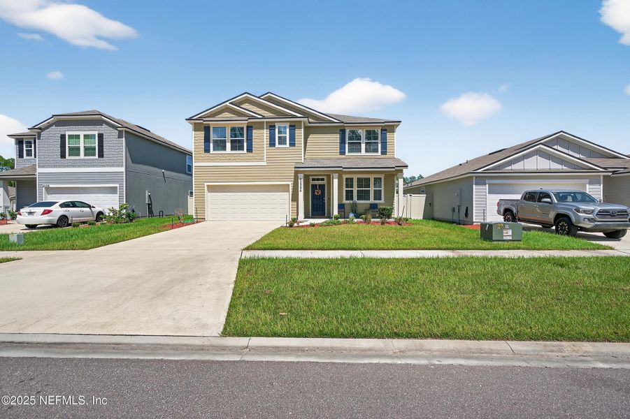 Front exterior of a new home in River Glen Express, Yulee, FL, highlighting curb appeal (Image 24).