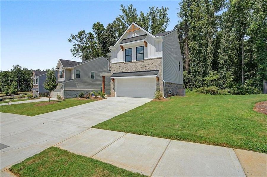 Front exterior of a new home in Sawmill Creek, Austell, GA, highlighting curb appeal (Image 24).
