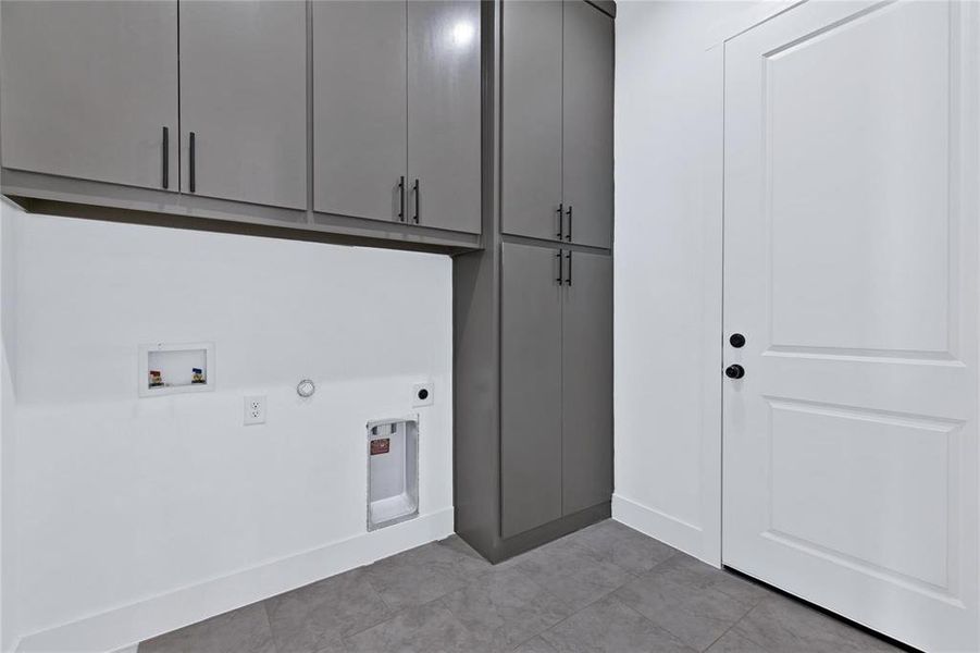 Laundry room featuring hookup for a gas dryer, washer hookup, electric dryer hookup, and cabinet space