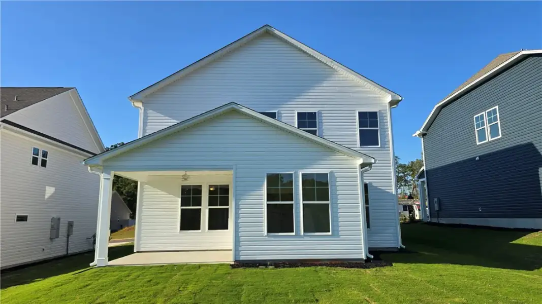 A classic gabled roofline and clean siding define