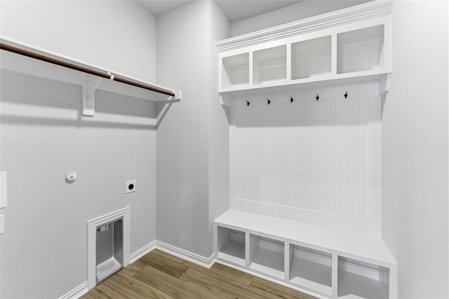 Mudroom featuring wood finished floors and baseboards