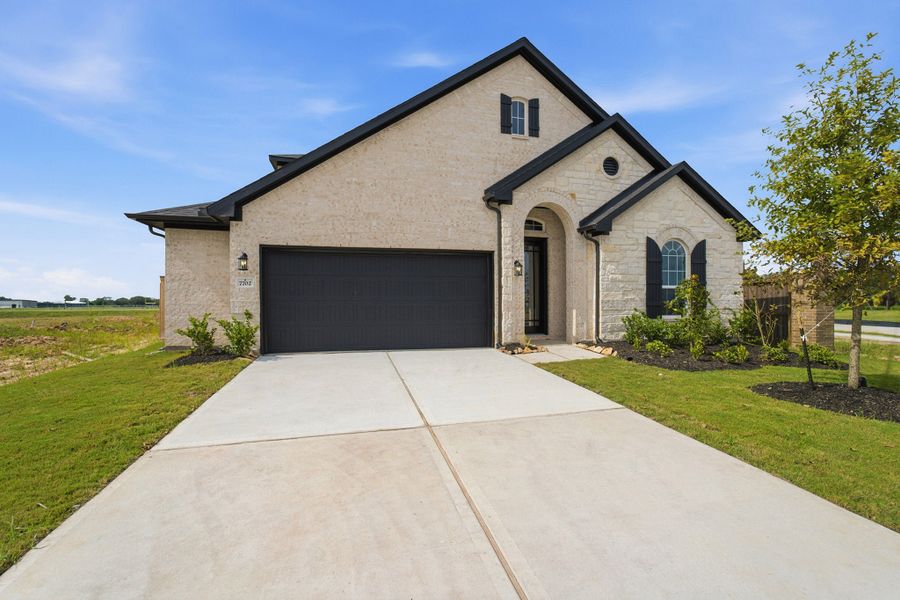 Front exterior of a new home in Ashland, Angleton, TX, highlighting curb appeal (Image 2).