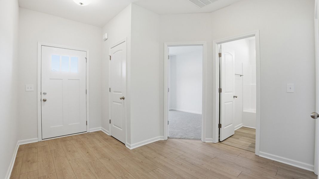 looking at the front door. coat closet behind front door looking at the front door. coat closet behind front door