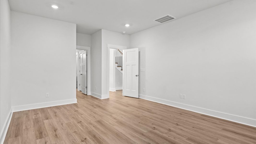 Vibrant natural light fills this exceptional primary suite with eye-catching details