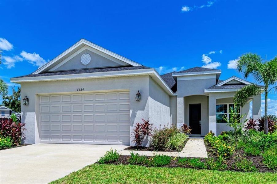 Front exterior of a new home in The Willows, Parrish, FL, highlighting curb appeal (Image 2).