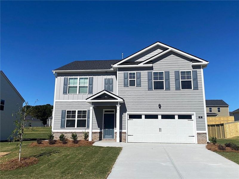 Front exterior of a new home in Preserve at Dove Creek, Statham, GA, highlighting curb appeal (Image 26). Front exterior of a new home in Preserve at Dove Creek, Statham, GA, highlighting curb appeal (Image 26).