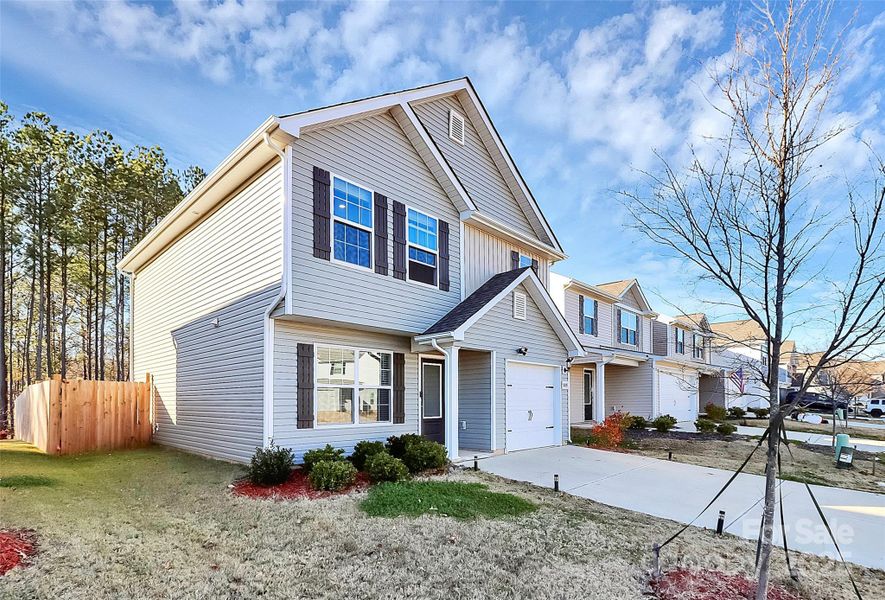 Front exterior of a new home in Creedmore Hills, Charlotte, NC, highlighting curb appeal (Image 1). Front exterior of a new home in Creedmore Hills, Charlotte, NC, highlighting curb appeal (Image 1).
