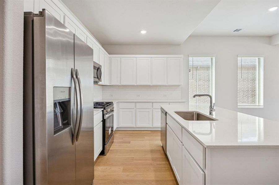 Kitchen in the Stanley II home plan by Trophy Signature Homes – REPRESENTATIVE PHOTO