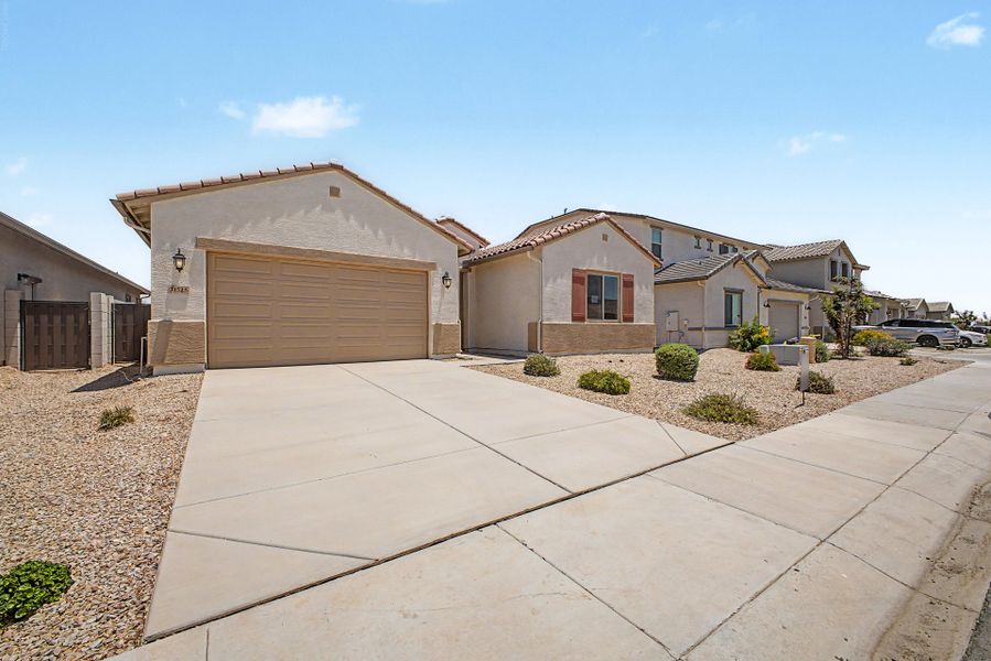 Front exterior of a new home in Wildera, San Tan Valley, AZ, highlighting curb appeal (Image 2). Front exterior of a new home in Wildera, San Tan Valley, AZ, highlighting curb appeal (Image 2).