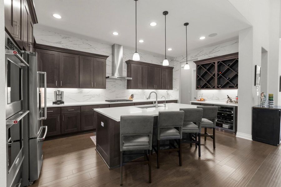 Culinary aspirations find a home in this modern kitchen with rich cabinetry and an expansive island.