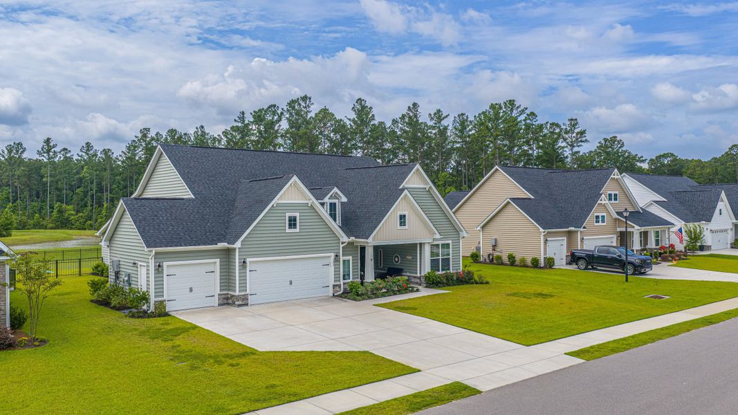 Front exterior of a new home in The Enclave at French Quarter Creek, Huger, SC, highlighting curb appeal (Image 24). Front exterior of a new home in The Enclave at French Quarter Creek, Huger, SC, highlighting curb appeal (Image 24).
