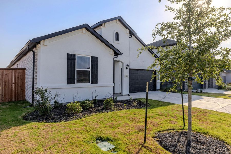 Front exterior of a new home in Lisso, Pflugerville, TX, highlighting curb appeal (Image 27). Front exterior of a new home in Lisso, Pflugerville, TX, highlighting curb appeal (Image 27).