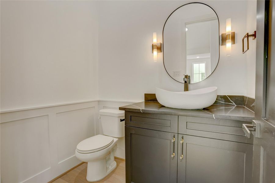The powder bathroom sits between the kitchen and living area on the second floor. The powder bathroom sits between the kitchen and living area on the second floor.