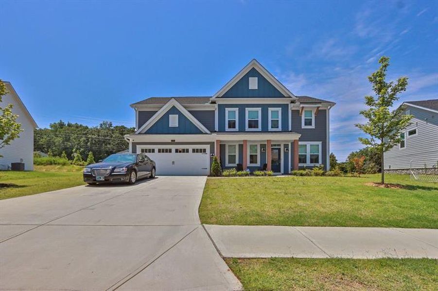 Front exterior of a new home in Sweetbay Farm, Lawrenceville, GA, highlighting curb appeal (Image 1).
