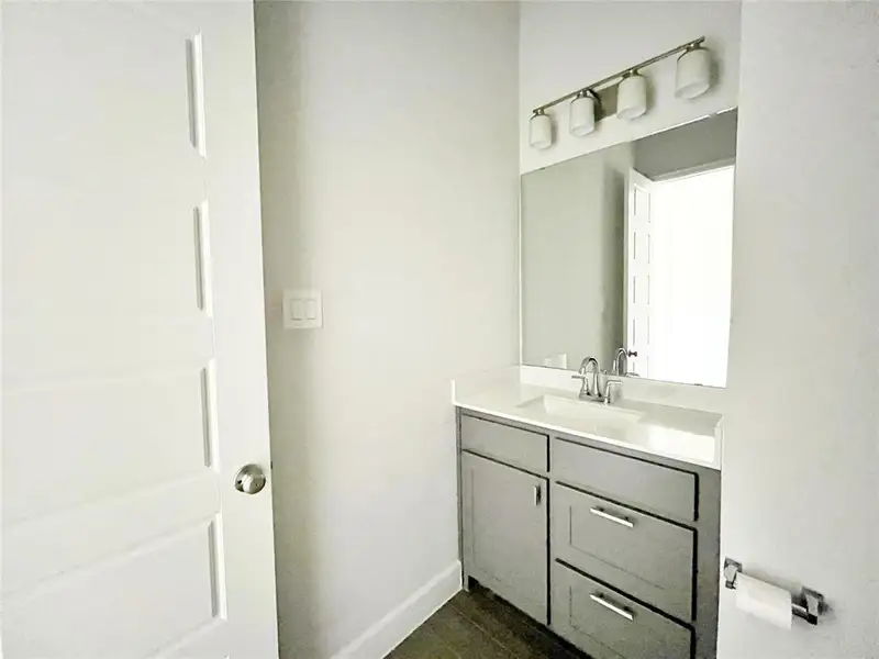 Bathroom featuring vanity and baseboards Bathroom featuring vanity and baseboards