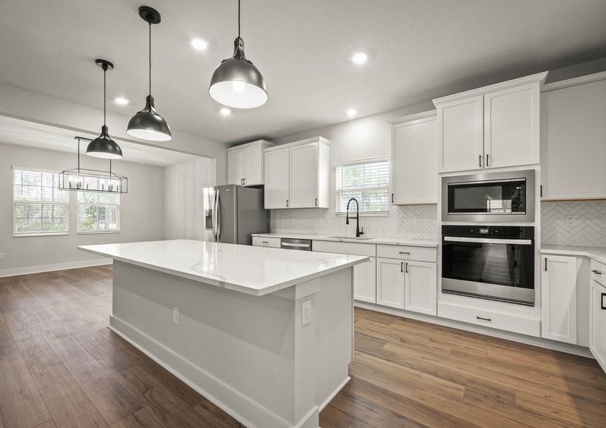 Kitchen with white cabinets and quartz countrtops.