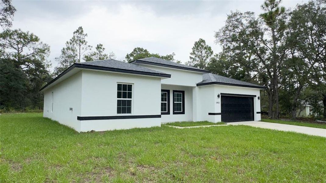 Front exterior of a new home in , Citrus Springs, FL, highlighting curb appeal (Image 21).