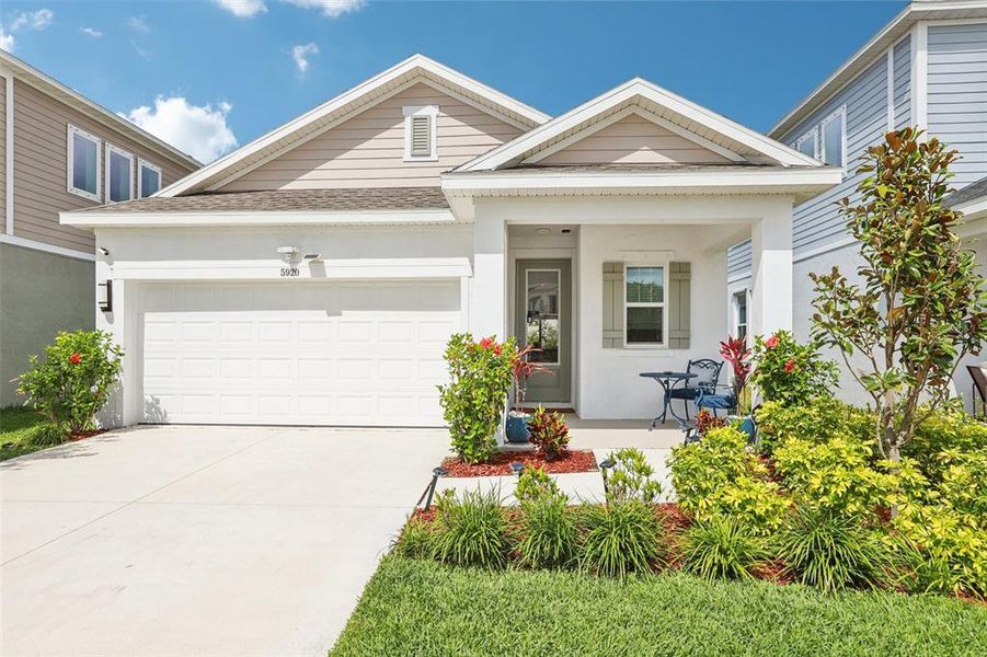 Front exterior of a new home in Waterset Garden Series, Apollo Beach, FL, highlighting curb appeal (Image 24).