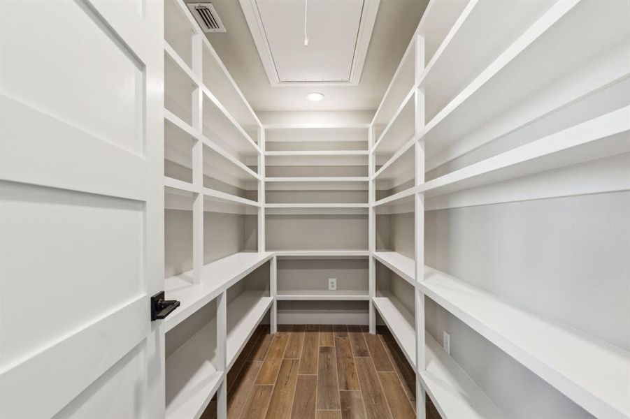 Pantry with shelves, outlet plugs and attic storage opening Pantry with shelves, outlet plugs and attic storage opening