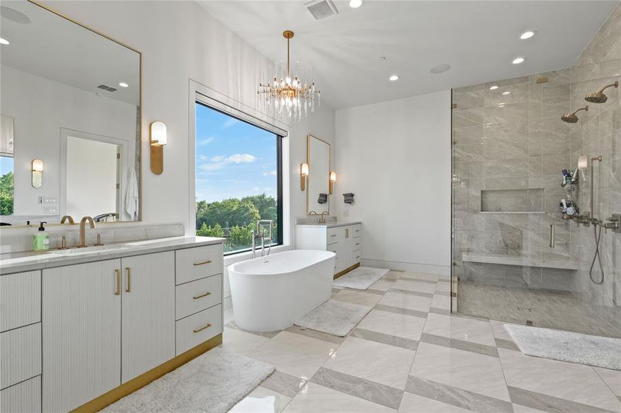 Bathroom with a shower stall, two vanities, a soaking tub, recessed lighting, and a chandelier Bathroom with a shower stall, two vanities, a soaking tub, recessed lighting, and a chandelier