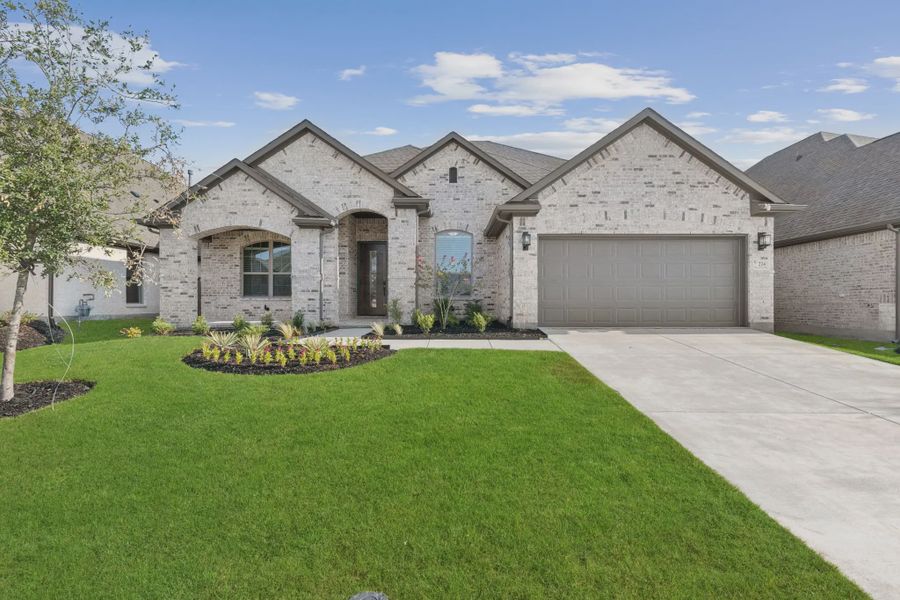 Front exterior of a new home in Trinity Falls, McKinney, TX, highlighting curb appeal (Image 1). Front exterior of a new home in Trinity Falls, McKinney, TX, highlighting curb appeal (Image 1).