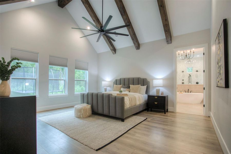 The owners suite features a vaulted ceiling with wooden beams.