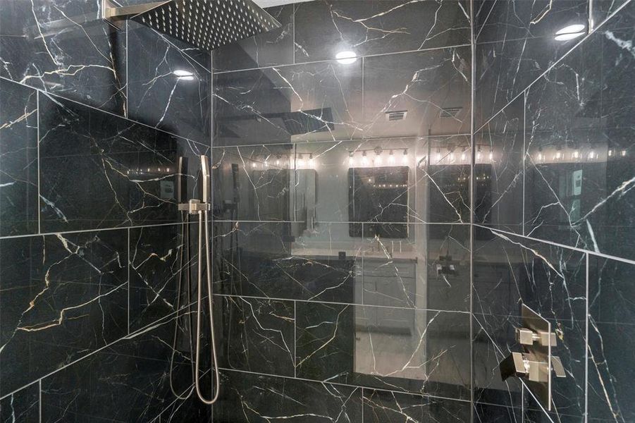Bathroom view of a marble finish shower