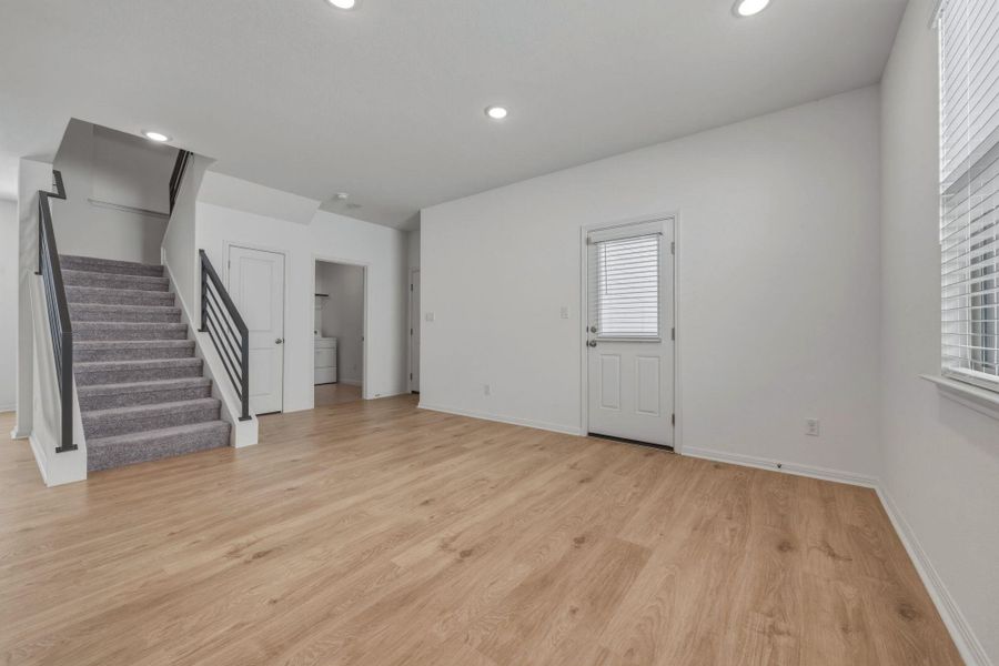 Unfurnished living room featuring light wood-style flooring and recessed lighting