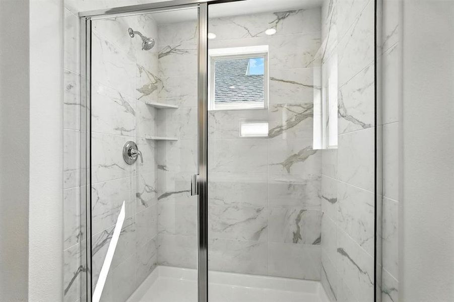 Bathroom featuring a marble finish shower Bathroom featuring a marble finish shower