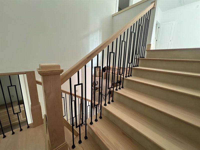 Wood stairs with wrought Iron railing