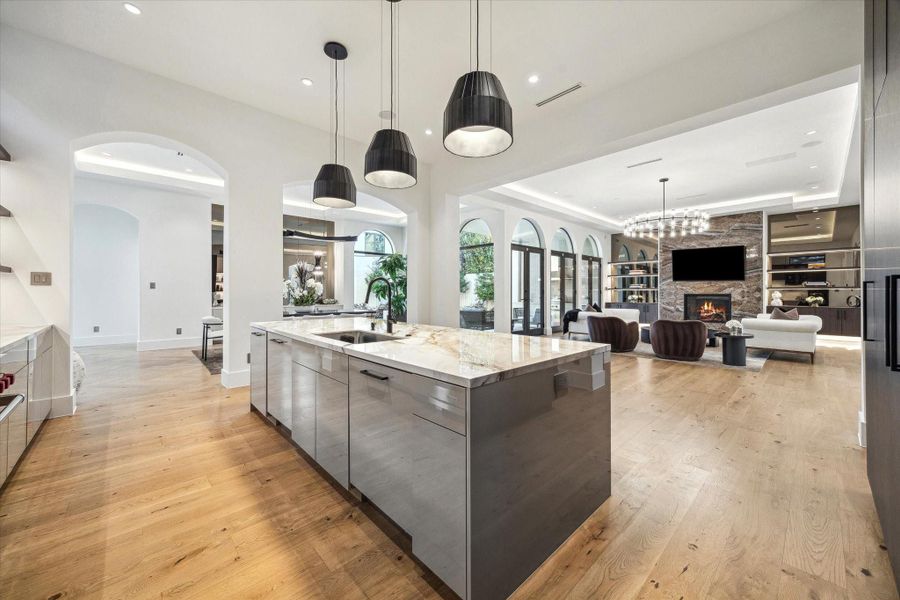 A kitchen with tone of chic sophistication and timeless elegance. Stylish pendent lights and soft-closing cabinetry and drawers