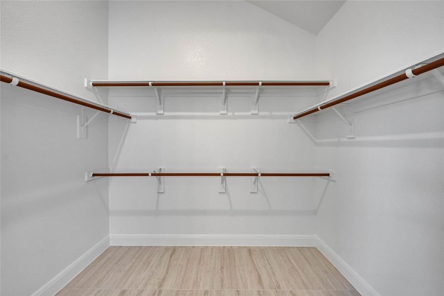 Spacious closet featuring light wood-type flooring Spacious closet featuring light wood-type flooring