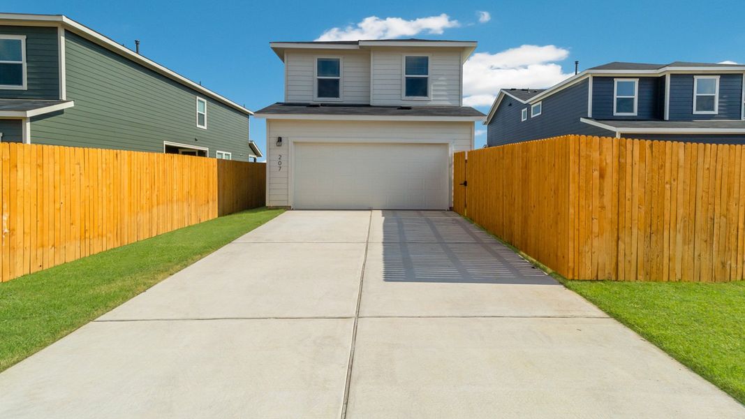 Front exterior of a new home in Valverde, Bastrop, TX, highlighting curb appeal (Image 12). Front exterior of a new home in Valverde, Bastrop, TX, highlighting curb appeal (Image 12).
