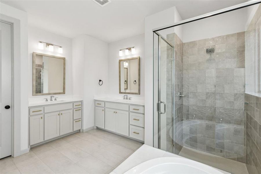 With his and her vanities, this lovely owner's bath offers plenty or space for two!