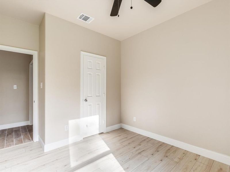 Spare room featuring ceiling fan and light wood-type flooring Spare room featuring ceiling fan and light wood-type flooring