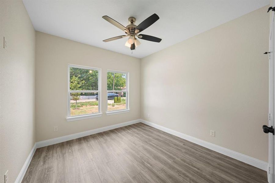 Unfurnished room with ceiling fan and wood-type flooring