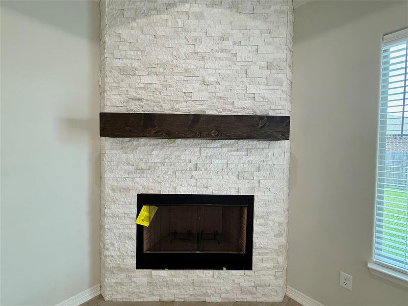 Detailed view of a fireplace and baseboards