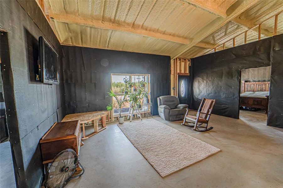 Living area featuring finished concrete flooring