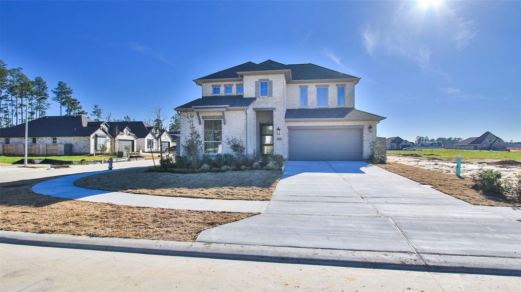 Front exterior of a new home in Artavia, Conroe, TX, highlighting curb appeal (Image 16).