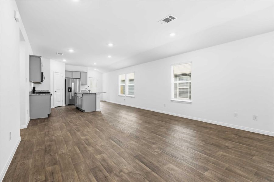 Easy maintenance wood-look luxury vinyl plank flooring runs throughout wit cozy carpeting in the bedrooms. Easy maintenance wood-look luxury vinyl plank flooring runs throughout wit cozy carpeting in the bedrooms.