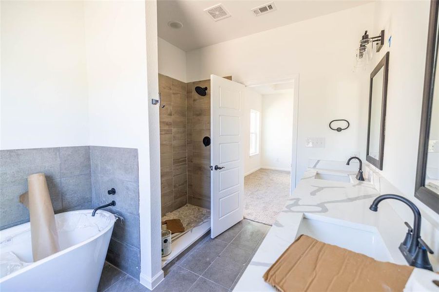 Bathroom featuring vanity, separate shower and tub, and tile patterned flooring