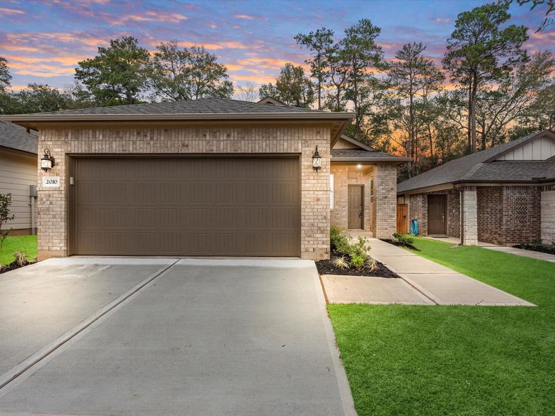 Front exterior of a new home in Montgomery Oaks - Premier, Conroe, TX, highlighting curb appeal (Image 18).