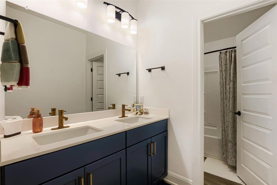 A well-appointed bathroom features a double vanity and sleek fixtures, perfect for modern living. A well-appointed bathroom features a double vanity and sleek fixtures, perfect for modern living.