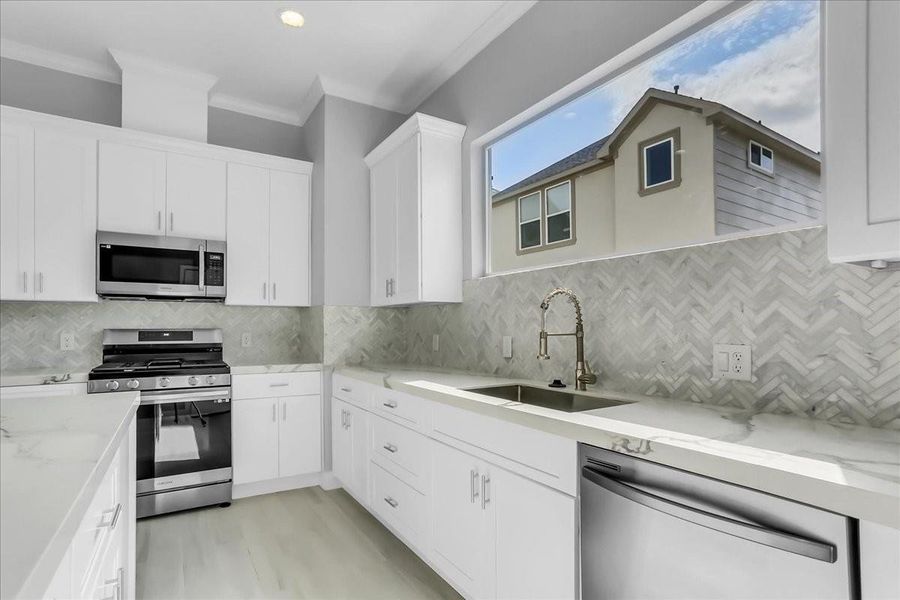 The kitchen boast with porcelain backsplash and stainless steel appliances. The kitchen boast with porcelain backsplash and stainless steel appliances.